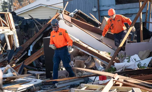 Alameda County Sheriff's Office Search and Rescue teams work the scene after a gas explosion Thursday, Dec. 11, 2025, in Hayward, Calif. (AP Photo/Minh Connors)