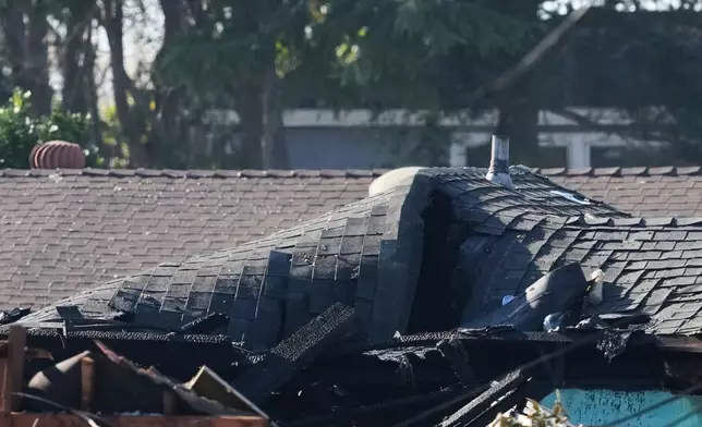 A damaged rooftop is shown at the scene of a gas explosion Thursday, Dec. 11, 2025, in Hayward, Calif. (AP Photo/Godofredo A. Vásquez)