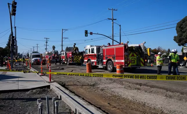 Emergency vehicles are lined up at the scene of a gas explosion Thursday, Dec. 11, 2025, in Hayward, Calif. (AP Photo/Godofredo A. Vásquez)
