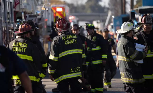 First responders and Pacific Gas &amp; Electric Co. workers at the site of a gas explosion in a neighborhood, Thursday, Dec. 11, 2025, in Hayward, Calif. (AP Photo/Minh Connors)