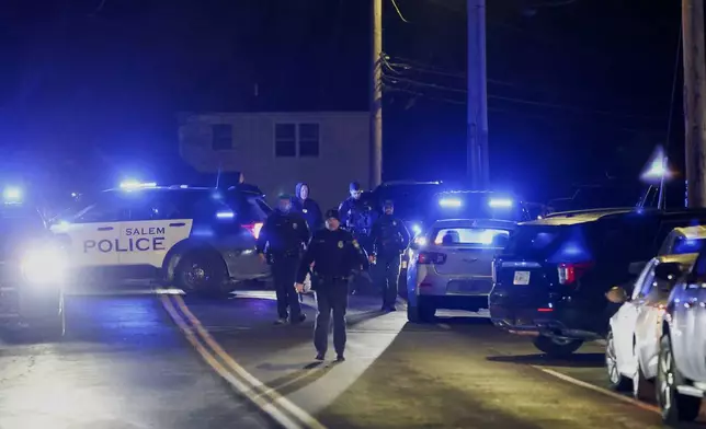 Law enforcement officers search the area for the Brown University shooting suspect, Thursday, Dec. 18, 2025, in Salem, N.H. (AP Photo/Reba Saldanha)