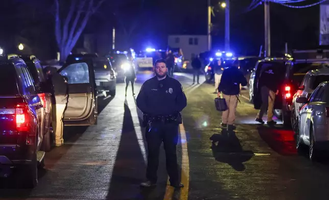 Law enforcement officers are seen outside a storage facility where a suspect in the shooting at Brown University was found dead, Thursday, Dec. 18, 2025, in Salem, N.H. (AP Photo/Reba Saldanha)