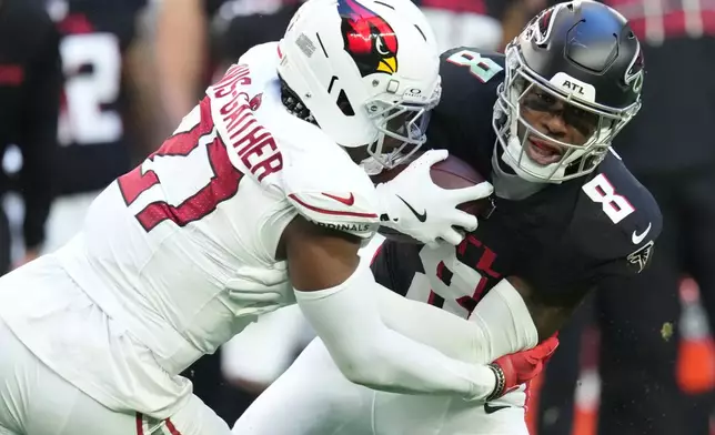 Atlanta Falcons tight end Kyle Pitts Sr. (8) makes the catch against Arizona Cardinals linebacker Akeem Davis-Gaither (27) during the first half of an NFL football game, Sunday, Dec. 21, 2025, in Glendale, Ariz. (AP Photo/Ross D. Franklin)