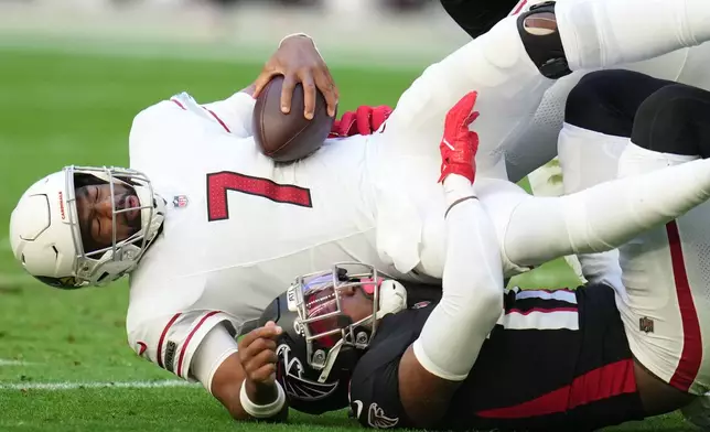 Atlanta Falcons linebacker Arnold Ebiketie (17) sacks Arizona Cardinals quarterback Jacoby Brissett (7) during the first half of an NFL football game, Sunday, Dec. 21, 2025, in Glendale, Ariz. (AP Photo/Rick Scuteri)