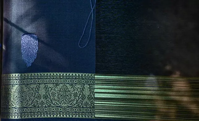 A Tangail saree takes shape on a loom at a traditional weaving workshop in Tangail District, Bangladesh, Nov. 5, 2025. (AP Photo/Mahmud Hossain Opu)