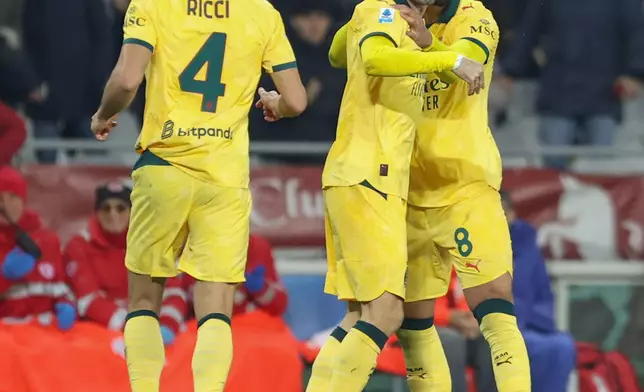 Milan's Christian Pulisic celebrates after scoring a goal during the Serie A soccer match between Torino FC and Milan in Turin, Italy, Monday, Dec. 8, 2025. (Tano Pecoraro/LaPresse via AP)