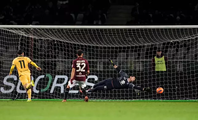 AC Milan's Christian Pulisic, left, scores his side's third goal goal during the Serie A soccer match between Torino FC and Milan in Turin, Italy, Monday, Dec. 8, 2025. (Fabio Ferrari/LaPresse via AP)