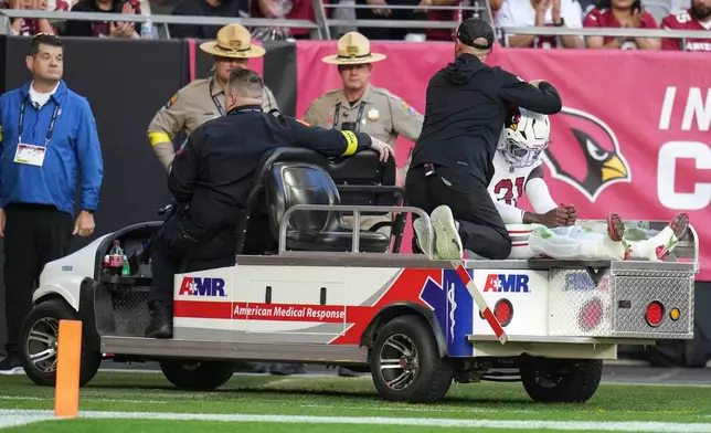 Arizona Cardinals cornerback Garrett Williams (21) is taken off the field due to injury against the Atlanta Falcons during the first half of an NFL football game, Sunday, Dec. 21, 2025, in Glendale, Ariz. (AP Photo/Rick Scuteri)