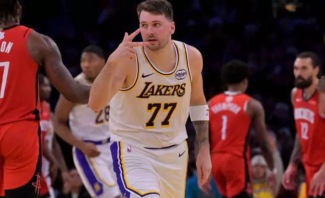 Los Angeles Lakers guard Luka Doncic reacts after a three-point basket during the first half of an NBA basketball game against the Houston Rockets, Thursday, Dec. 25, 2025, in Los Angeles. (AP Photo/Jayne Kamin-Oncea)