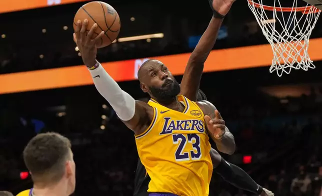 Los Angeles Lakers forward Lebron James shoots against the Phoenix Suns during the first half of an NBA basketball game, Tuesday, Dec. 23, 2025, in Phoenix. (AP Photo/Rick Scuteri)