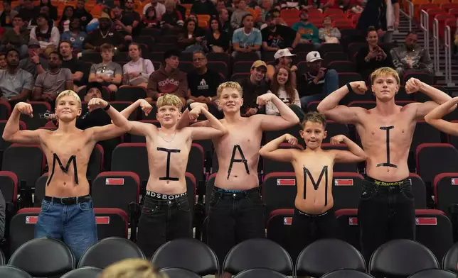 Fans pose for a photo before an NBA basketball game between the Miami Heat and the Indiana Pacers, Saturday, Dec. 27, 2025, in Miami. (AP Photo/Lynne Sladky)