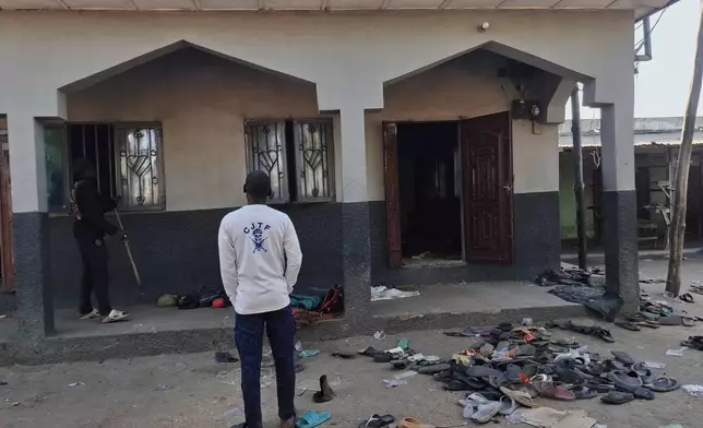 People inspect the scene of a deadly bomb explosion at a mosque in Maiduguri, Nigeria, Thursday, Dec. 25, 2025. (AP Photo/Jossy Ola)