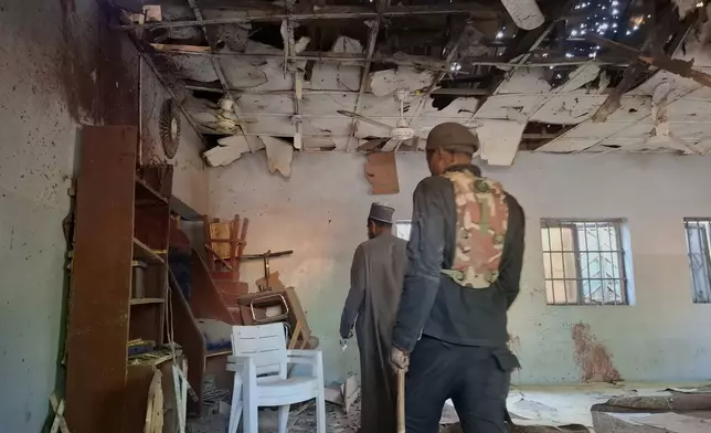 People inspect the scene of a deadly bomb explosion inside a mosque in Maiduguri, Nigeria, Thursday, Dec. 25, 2025. (AP Photo/Jossy Ola)