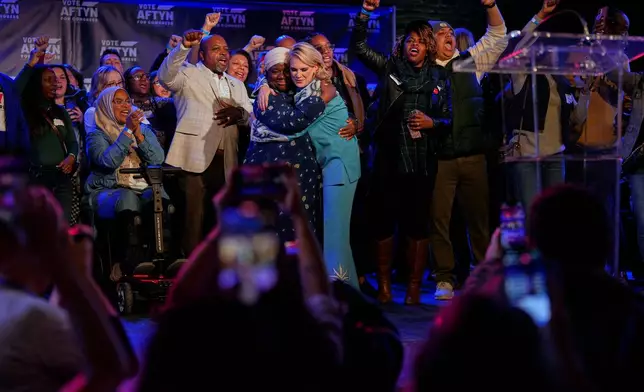 Democratic candidate State Rep. Aftyn Behn, D-Nashville, center right, hugs Zulfat Suara, center left, after losing a special election for the U.S. seventh congressional district Tuesday, Dec. 2, 2025, in Nashville, Tenn. (AP Photo/George Walker IV)
