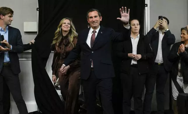 Republican candidate Matt Van Epps comes out with wife Meg Van Epps, left, at a watch party to announce victory in a special election for the U.S. seventh congressional district, Tuesday, Dec. 2, 2025, in Nashville, Tenn. (AP Photo/John Amis)