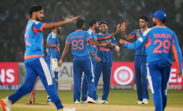 India's players celebrate the wicket of South Africa's captain Aiden Markram during the first T20 International cricket match between India and South Africa in Cuttack, India, Tuesday, Dec. 9, 2025. (AP Photo/Rafiq Maqbool)
