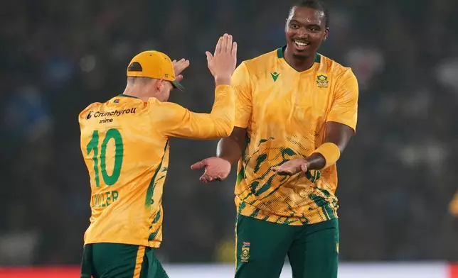South Africa's Lungi Ngidi, right, celebrates with teammate the wicket of India's captain Suryakumar Yadav during the first T20 International cricket match between India and South Africa in Cuttack, India, Tuesday, Dec. 9, 2025. (AP Photo/Rafiq Maqbool)