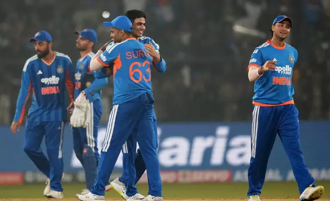 India's captain Suryakumar Yadav, centre, with teammates celebrates after winning the first T20 International cricket match between India and South Africa in Cuttack, India, Tuesday, Dec. 9, 2025. (AP Photo/Rafiq Maqbool)