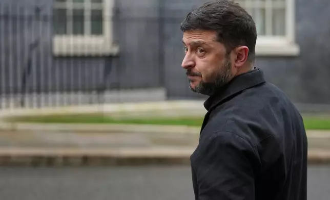 FILE - Ukrainian President Volodymyr Zelenskyy, looks back at the media in Downing Street, London, Monday, Dec. 8, 2025. (AP Photo/Kin Cheung, File)