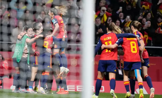 Spain players celebrate after Spain's Claudia Pina scored her side's opening goal during the Women's Nations League final soccer match between Spain and Germany in Madrid, Spain, Tuesday, Dec. 2, 2025. (AP Photo/Bernat Armangue)