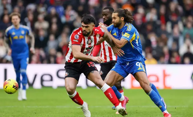 Sunderland's Omar Alderete battles for the ball against Leeds United's Dominic Calvert-Lewin, right, during the English Premier League soccer match in Sunderland, England, Sunday, Dec. 28, 2025. (Owen Humphreys/PA via AP)