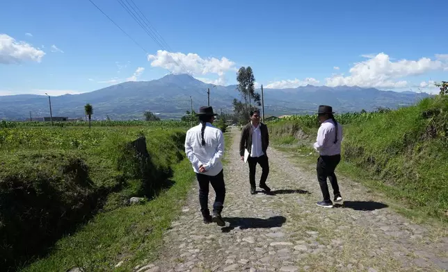 From left, Malkik Anrango, Yarik Sisa and Tupac Amaru walk among landscape they aim to capture in "Aya Somos," the first Quichua animated short, blending Otavalo culture with Japanese-style anime, in Hatun Rumi, Ecuador, Wednesday, Dec. 3, 2025. (AP Photo/Dolores Ochoa)