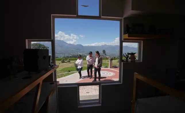 From left, Malkik Anrango, Tupac Amaru and Yarik Sisa chat about "Aya Somos," the first Quichua animated short, blending Otavalo culture with Japanese-style anime, in the courtyard of the Yay Animación studio in Hatun Rumi, Ecuador, Wednesday, Dec. 3, 2025. (AP Photo/Dolores Ochoa)