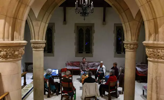 Participants meditate in silence during an interfaith meditation practice at All Saints Episcopal Church in Pasadena, Calif., on Monday, Dec. 15, 2025. (AP Photo/William Liang)