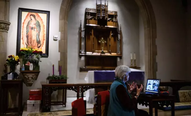 Betty Cole, right, connects with some participants through video call for an interfaith meditation practice at All Saints Episcopal Church in Pasadena, Calif., on Monday, Dec. 15, 2025. (AP Photo/William Liang)