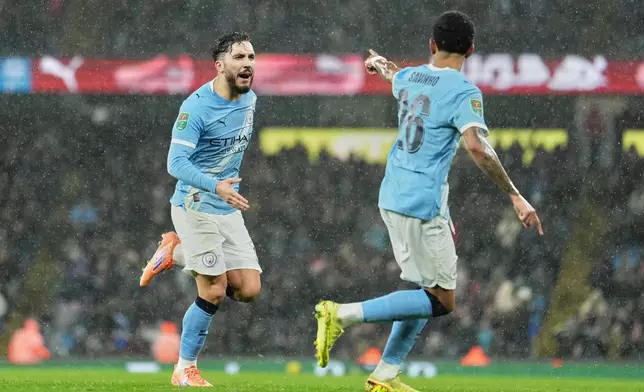 Manchester City's Rayan Cherki celebrates after scoring his side's first goal during the English League Cup soccer match between Manchester City and Brentford in Manchester, England, Wednesday, Dec. 17, 2025. (AP Photo/Jon Super)