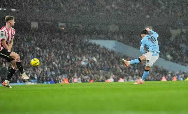 Manchester City's Rayan Cherki scores his side's first goal during the English League Cup soccer match between Manchester City and Brentford in Manchester, England, Wednesday, Dec. 17, 2025. (AP Photo/Jon Super)