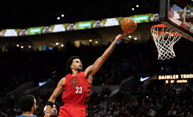 Portland Trail Blazers forward Toumani Camara drives to the basket against the Orlando Magic during the second half of an NBA basketball game Tuesday Dec. 23, 2025, in Portland, Ore. (AP Photo/Howard Lao)