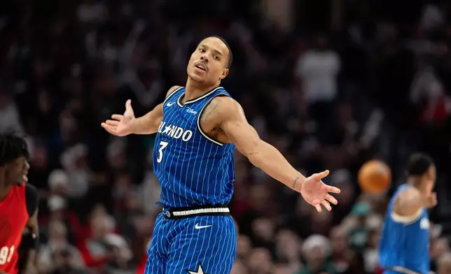 Orlando Magic guard Desmond Bane reacts to the made shot against the Portland Trail Blazers during the second half of an NBA basketball game Tuesday Dec. 23, 2025, in Portland, Ore. (AP Photo/Howard Lao)