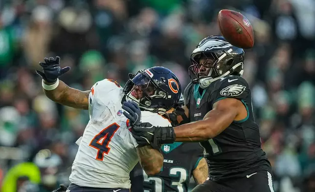Chicago Bears running back D'Andre Swift (4), left, and Philadelphia Eagles linebacker Nakobe Dean (17) vie for a loose ball during the first half of an NFL football game, Friday, Nov. 28, 2025, in Philadelphia. (AP Photo/Matt Rourke)