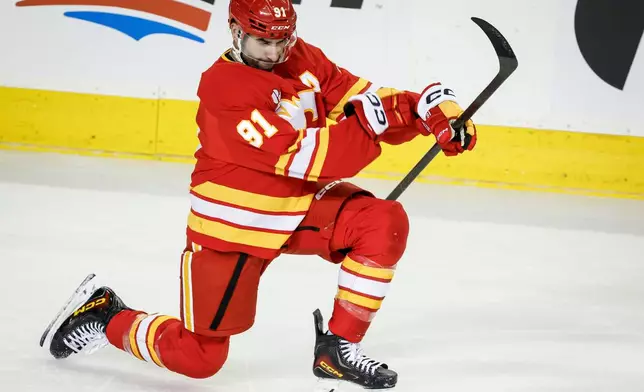 Calgary Flames' Nazem Kadri celebrates after his goal during third-period NHL hockey game action against the Seattle Kraken in Calgary, Alberta, Thursday, Dec. 18, 2025. (Jeff McIntosh/The Canadian Press via AP)