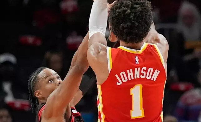Atlanta Hawks forward Jalen Johnson (1) shoots against Chicago Bulls forward Isaac Okoro (35) during the first half of an NBA basketball game, Tuesday, Dec. 23, 2025, in Atlanta. (AP Photo/Mike Stewart)