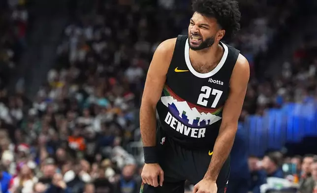Denver Nuggets guard Jamal Murray grimaces after losing control of the ball in the first half of an NBA basketball game against the Minnesota Timberwolves, Thursday, Dec. 25, 2025, in Denver. (AP Photo/David Zalubowski)