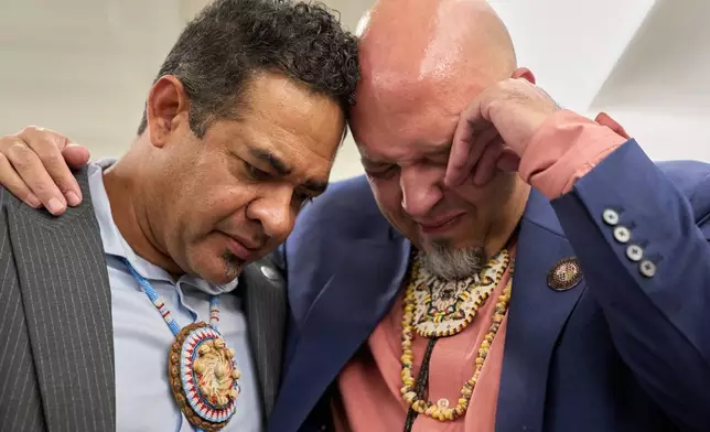 John Lowery, N.C. State Rep. and Chairman of the Lumbee Tribe of N.C., right, is comforted by Rob Jacobs, as they join with other members of the Lumbee Tribe of North Carolina, to celebrate with hugs, tears, and prayers after the passage of a bill granting their people with federal recognition, on Capitol Hill, in Washington, Wednesday, Dec. 17, 2025. "It means a lot," says Lowery, "because we have been figuring out how to get here for so long. We have been second class natives, and we will never be that again. We will make sure this counts." (AP Photo/Jacquelyn Martin)