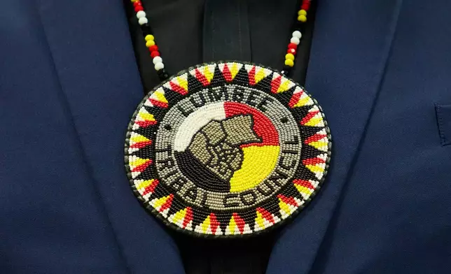 Wearing a traditional bolo that says "Lumber Tribal Council," a member of the Lumbee Tribe of North Carolina, attends a celebration after the passage of a bill granting the tribe with federal recognition, on Capitol Hill, in Washington, Wednesday, Dec. 17, 2025. (AP Photo/Jacquelyn Martin)
