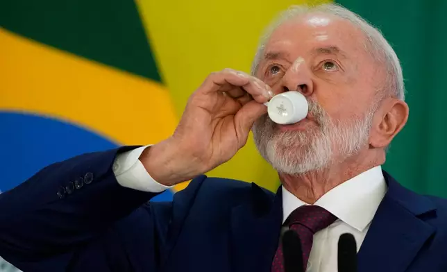 Brazilian President Luiz Inacio Lula da Silva takes a sip of coffee during a year-end press conference at Planalto presidential palace in Brasilia, Brazil, Thursday, Dec. 18, 2025. (AP Photo/Eraldo Peres)