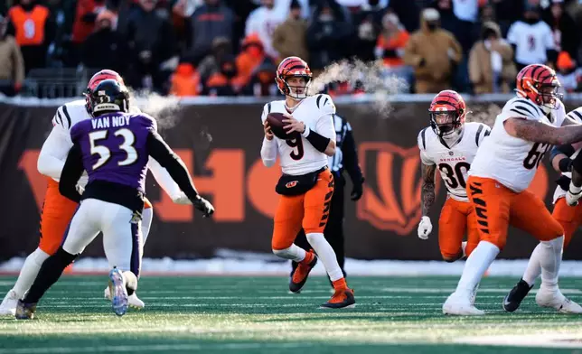 Cincinnati Bengals quarterback Joe Burrow (9) looks to throw against the Baltimore Ravens during the first half of an NFL football game, Sunday, Dec. 14, 2025, in Cincinnati. (AP Photo/Carolyn Kaster)