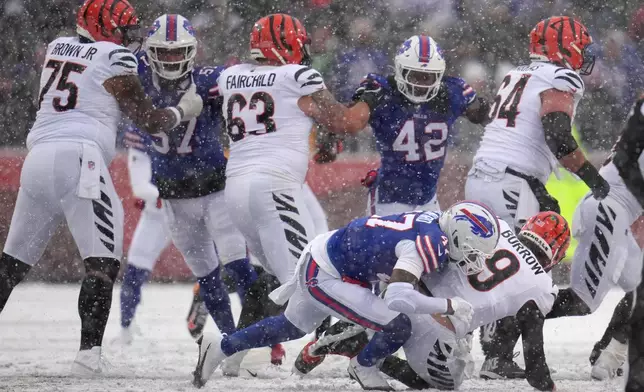 Cincinnati Bengals quarterback Joe Burrow (9) is sacked by Buffalo Bills cornerback Christian Benford (47) during the first half of an NFL football game, Sunday, Dec. 7, 2025, in Orchard Park, N.Y. (AP Photo/Gene J. Puskar)