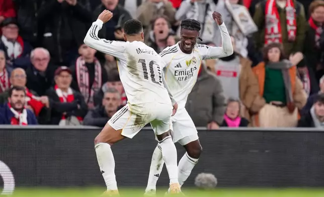 Real Madrid's Eduardo Camavinga, right, celebrates with Real Madrid's Kylian Mbappe after scoring his side's second goal during the Spanish La Liga soccer match between Athletic Bilbao and Real Madrid in Bilbao, Spain, Wednesday, Dec. 3, 2025. (AP Photo/Jose Breton)