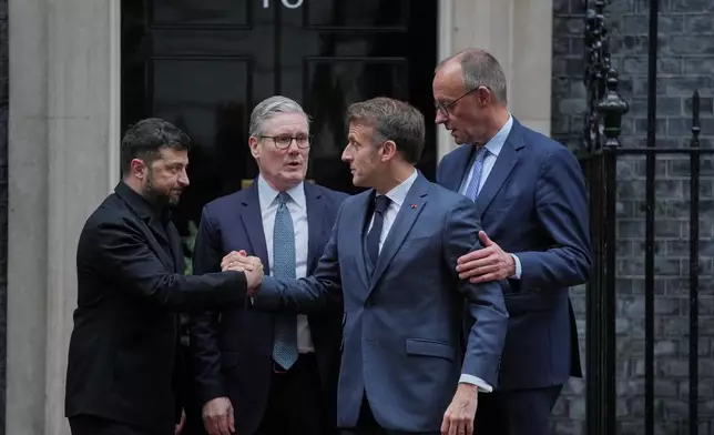 Ukrainian President Volodymyr Zelenskyy, left, with Britain's Prime Minister Keir Starmer, French President Emmanuel Macron, and German Chancellor Friedrich Merz pose on the doorstep of 10 Downing Street, London, Monday, Dec. 8, 2025, following a meeting of the leaders inside. (AP Photo/Kin Cheung)