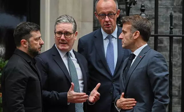 Ukrainian President Volodymyr Zelenskyy, left, with Britain's Prime Minister Keir Starmer, German Chancellor Friedrich Merz, and French President Emmanuel Macron, talk on the doorstep of 10 Downing Street, London, Monday, Dec. 8, 2025, following a meeting of the leaders inside. (AP Photo/Thomas Krych)