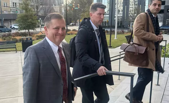 FILE - Front Row Motorsports owner Bob Jenkins, left, and 23XI co-owner Denny Hamlin arrive in the Western District of North Carolina on Monday Dec 1, 2025 in Charlotte, N.C. (AP Photo/Jenna Fryer, File)