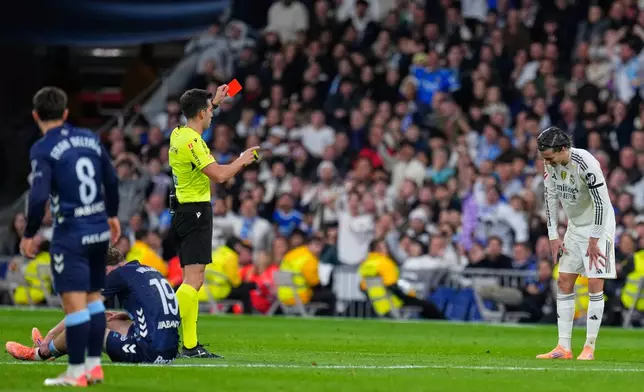 Real Madrid's Alvaro Carreras gets a red card during the Spanish La Liga soccer match between Real Madrid and Celta Vigo in Madrid, Spain, Sunday, Dec. 7, 2025. (AP Photo/Manu Fernandez)