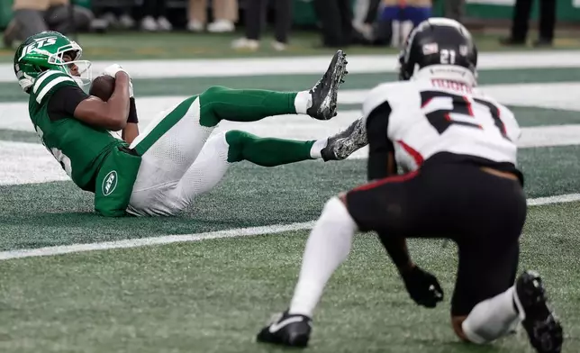 New York Jets wide receiver Adonai Mitchell (15) scores a touchdown against the Atlanta Falcons during the second half of an NFL football game, Sunday, Nov. 30, 2025, in East Rutherford, N.J. (AP Photo/Adam Hunger)