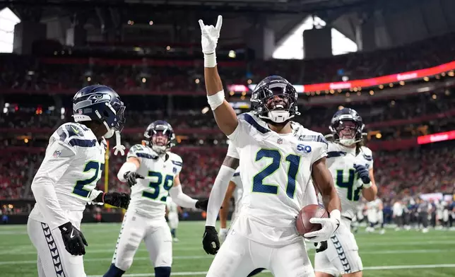 Seattle Seahawks cornerback Devon Witherspoon celebrates a fumble recovery against the Atlanta Falcons during the second half of an NFL football game, Sunday, Dec. 7, 2025, in Atlanta. (AP Photo/Mike Stewart)