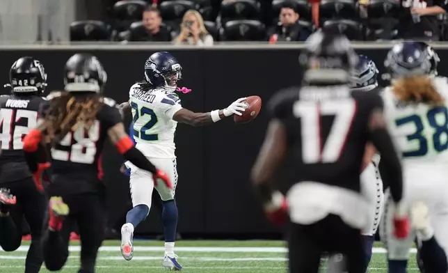 Seattle Seahawks wide receiver Rashid Shaheed (22) looks back as he runs for a touchdown on a kickoff return against the Atlanta Falcons during the second half of an NFL football game, Sunday, Dec. 7, 2025, in Atlanta. (AP Photo/Mike Stewart)